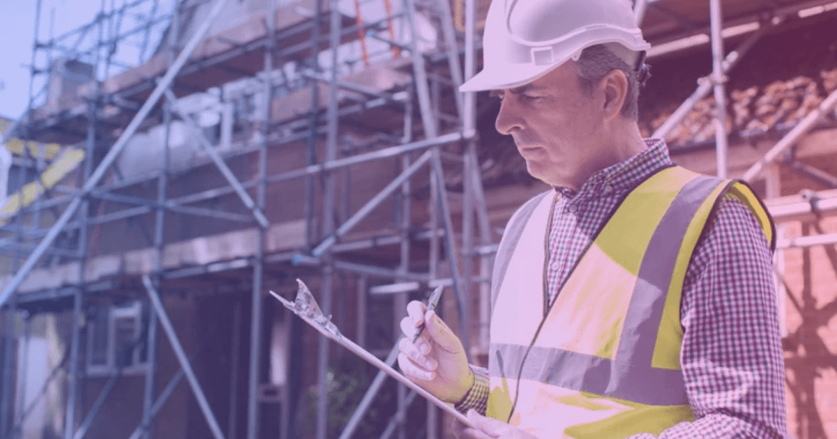 Building inspector reviewing checklist on site