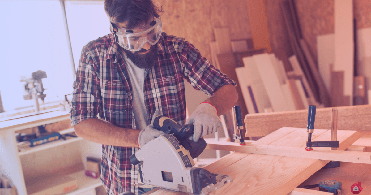 Carpenter measuring and marking wood for cutting