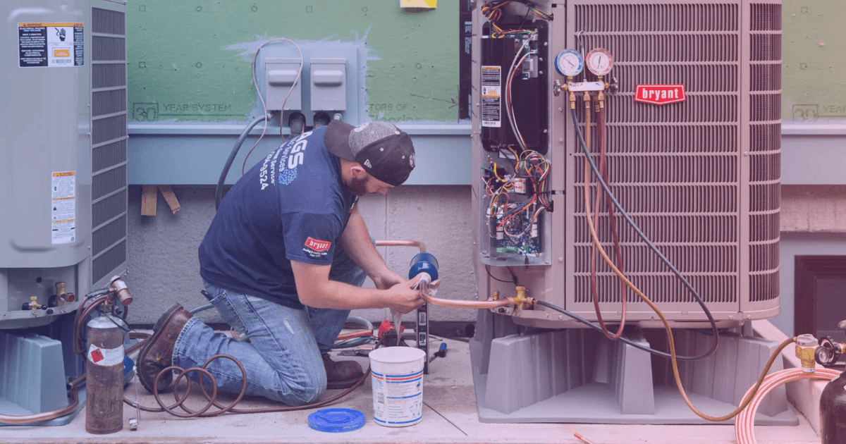 HVAC technician installing air conditioning unit